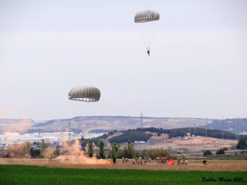 Dos paracaidistas del EADA a punto de aterrizar en el punto de impacto señalado por los CCT´s con un bote de humo de color rojo. Dos paracaidistas del EADA a punto de aterrizar en el punto de impacto señalado por los CCT´s con un bote de humo de color rojo.