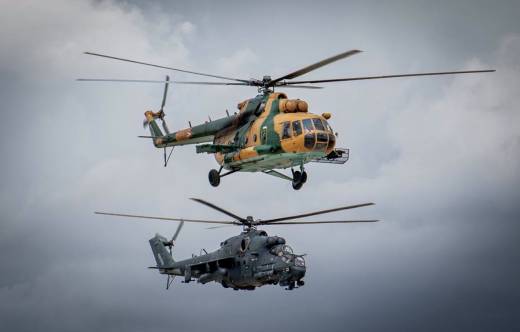 Vuelo en formaci�n final de un Mi-17 (arriba) y Mi-24, durante la ceremonia de despedida de ambos modelos.  (Foto Magyar Honv�ds�g) 