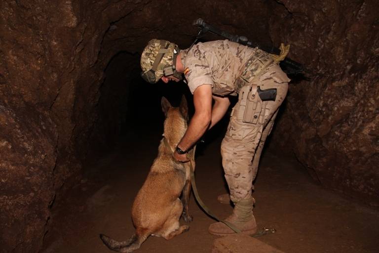 Un perro y su guía preparándose para introducirse en una mina